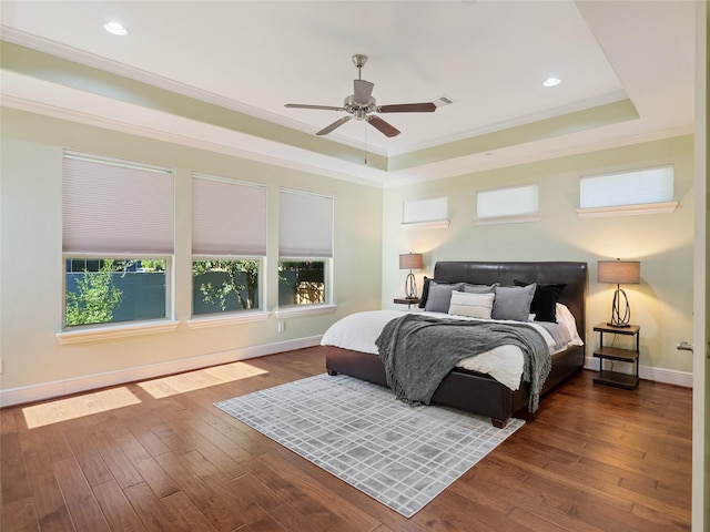 4635 Beech St, Bellaire, TX 77401 - bedroom with a raised ceiling, multiple windows, wood-type flooring, crown molding, and baseboards