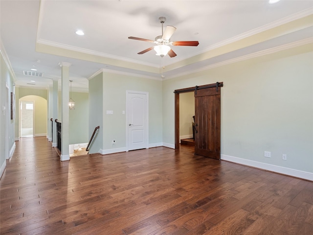 4635 Beech St, Bellaire, TX 77401 - spare room with arched walkways, dark wood-style flooring, a ceiling fan, a barn door, and recessed lighting