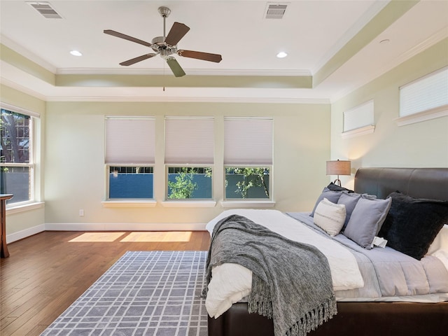 4635 Beech St, Bellaire, TX 77401 - bedroom featuring a raised ceiling, ornamental molding, hardwood / wood-style flooring, a ceiling fan, and baseboards