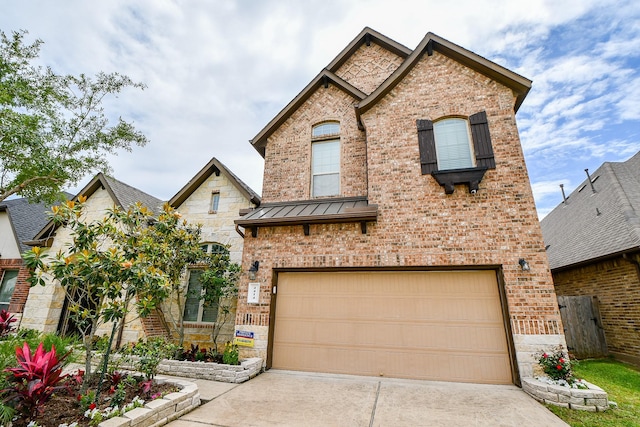 4414 Tilbury Trl, Richmond, TX 77407 - french country home featuring concrete driveway, a garage, brick siding, and a standing seam roof
