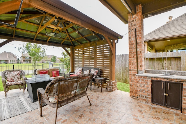 4414 Tilbury Trl, Richmond, TX 77407 - view of patio featuring a gazebo, outdoor lounge area, a fenced backyard, and a sink