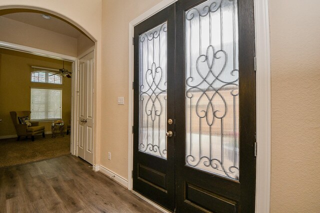 4414 Tilbury Trl, Richmond, TX 77407 - entrance foyer with arched walkways, dark wood finished floors, baseboards, and french doors