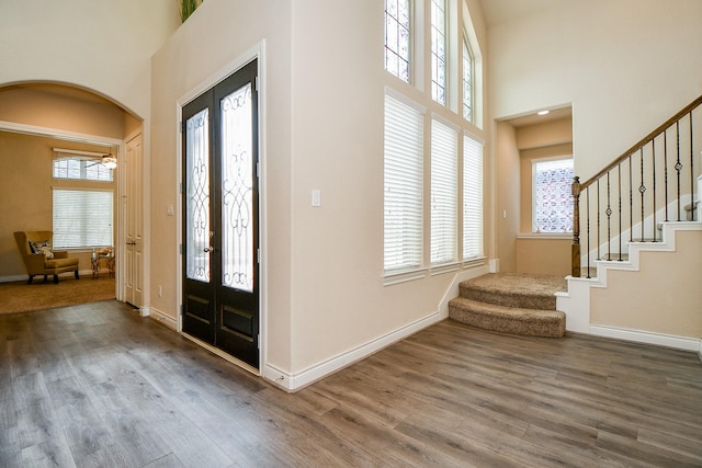 4414 Tilbury Trl, Richmond, TX 77407 - entryway with stairs, a high ceiling, wood finished floors, and healthy amount of natural light