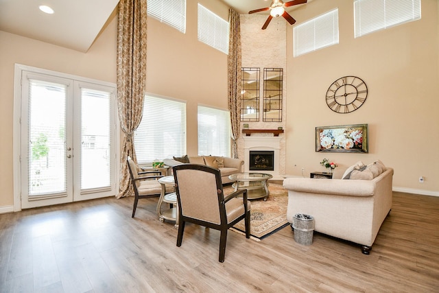 4414 Tilbury Trl, Richmond, TX 77407 - living room featuring french doors, a high ceiling, plenty of natural light, ceiling fan, and light wood-style floors