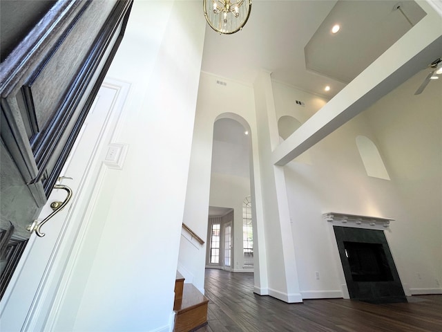 1265 Ridgewood Pl, Houston, TX 77055 - unfurnished living room featuring a high ceiling, dark wood-style flooring, stairs, baseboards, and a fireplace