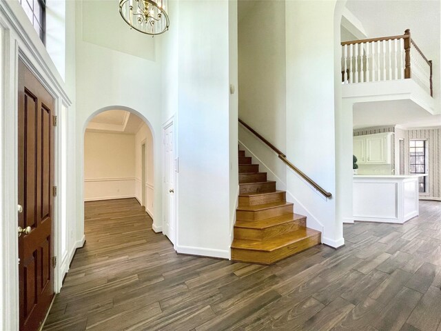 1265 Ridgewood Pl, Houston, TX 77055 - entrance foyer featuring a high ceiling, dark wood-style flooring, arched walkways, a chandelier, and stairs