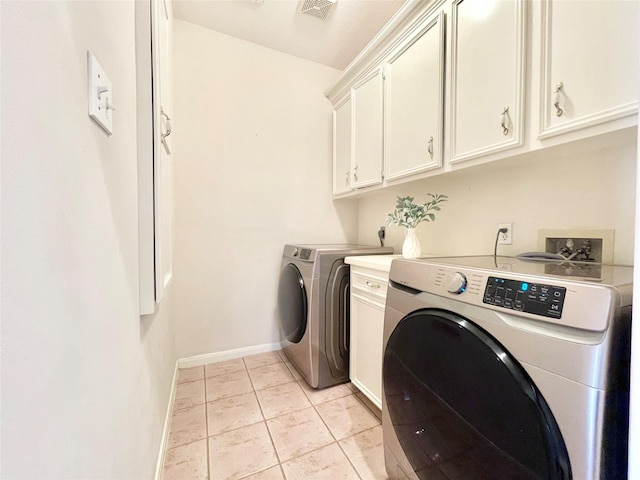1265 Ridgewood Pl, Houston, TX 77055 - laundry area featuring washing machine and clothes dryer, cabinet space, and baseboards