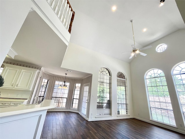 1265 Ridgewood Pl, Houston, TX 77055 - unfurnished living room featuring ceiling fan, dark wood-style floors, a chandelier, high vaulted ceiling, and baseboards