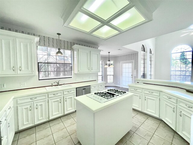1265 Ridgewood Pl, Houston, TX 77055 - kitchen with a sink, white gas stovetop, stainless steel dishwasher, and light countertops