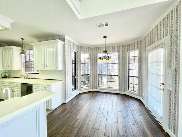 1265 Ridgewood Pl, Houston, TX 77055 - unfurnished dining area featuring dark wood-style flooring, crown molding, wallpapered walls, a chandelier, and baseboards