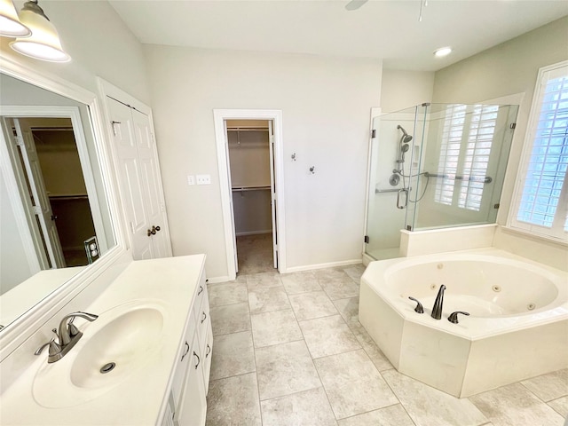 1265 Ridgewood Pl, Houston, TX 77055 - full bathroom with a stall shower, a whirlpool tub, vanity, a walk in closet, and a ceiling fan
