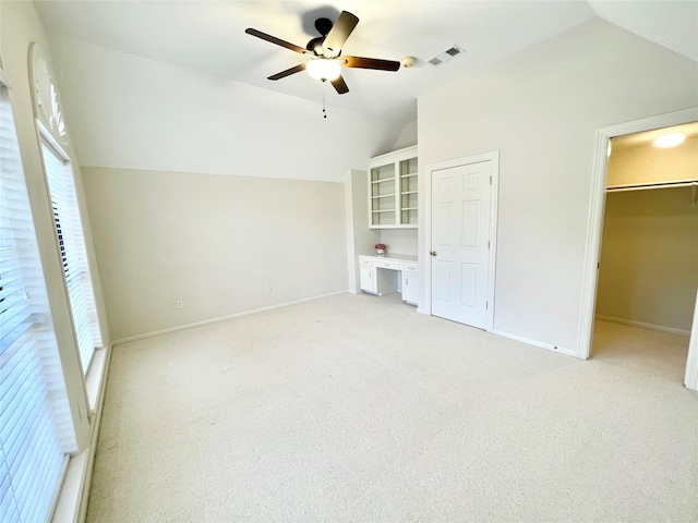 1265 Ridgewood Pl, Houston, TX 77055 - unfurnished bedroom with vaulted ceiling, light colored carpet, multiple windows, and baseboards