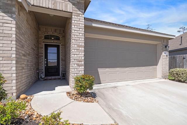 entrance to property featuring driveway and a garage