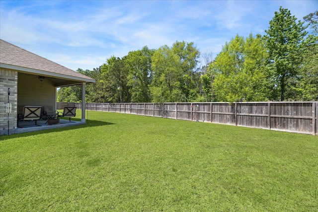 view of yard with ceiling fan