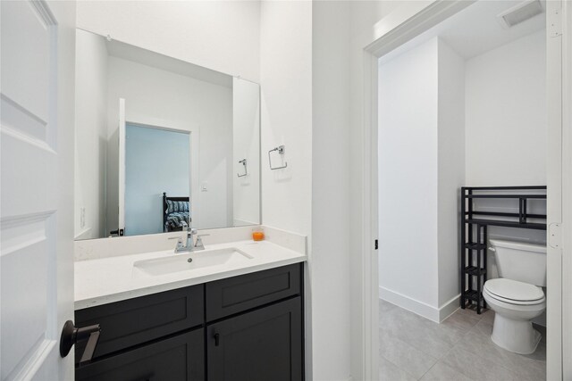 21502 Lowlands Ln, Cypress, TX 77433 - bathroom featuring toilet, vanity, tile patterned flooring, and baseboards