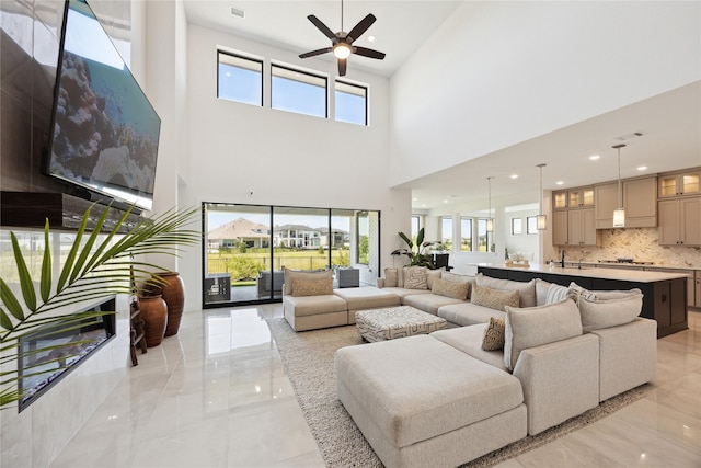 21502 Lowlands Ln, Cypress, TX 77433 - living area featuring ceiling fan, a towering ceiling, light marble finish floors, and recessed lighting