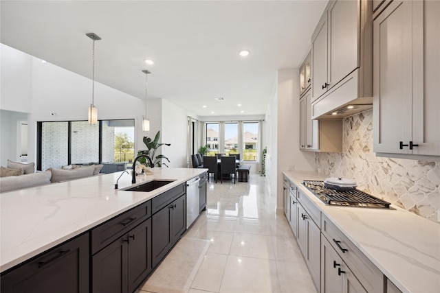 21502 Lowlands Ln, Cypress, TX 77433 - kitchen with a sink, open floor plan, tasteful backsplash, appliances with stainless steel finishes, and light stone countertops