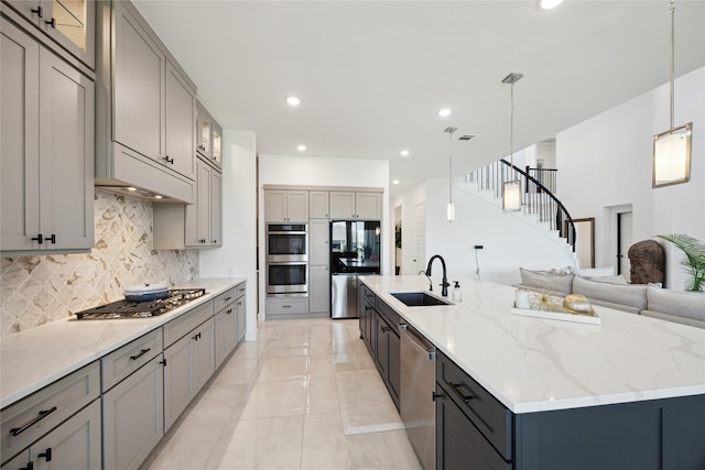 21502 Lowlands Ln, Cypress, TX 77433 - kitchen with a sink, appliances with stainless steel finishes, gray cabinetry, decorative backsplash, and recessed lighting