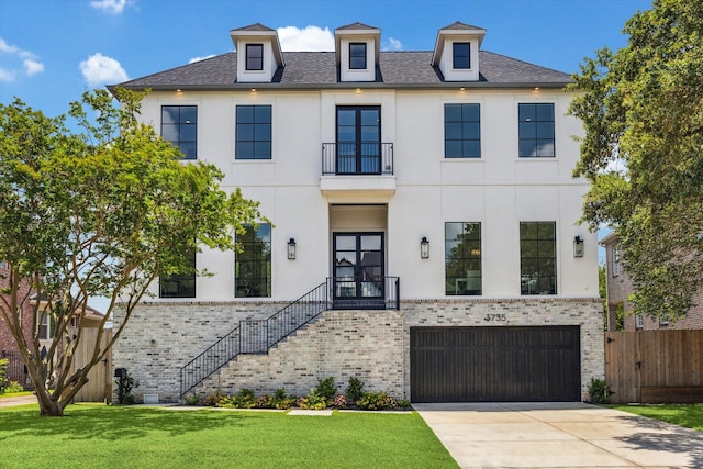 view of front facade featuring stairway, a balcony, an attached garage, stucco siding, and driveway