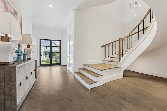 foyer entrance featuring stairs, baseboards, wood finished floors, ornamental molding, and recessed lighting