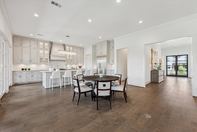 dining area featuring crown molding, dark wood-type flooring, recessed lighting, and baseboards