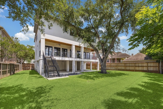 back of property featuring stairs, ceiling fan, a patio area, and stucco siding