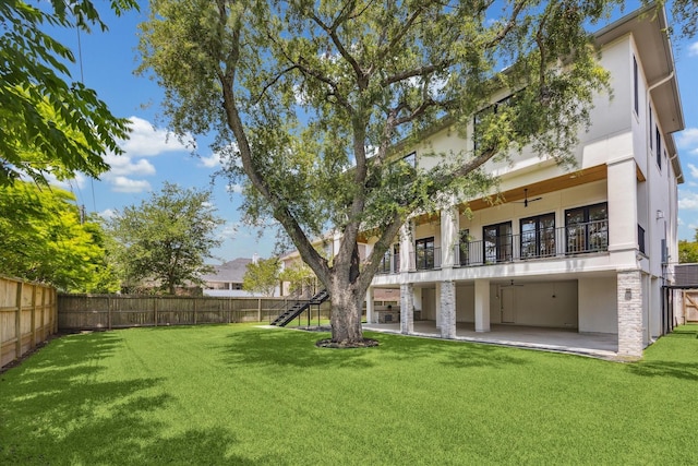 back of property featuring stucco siding, a patio, a balcony, ceiling fan, and stairs