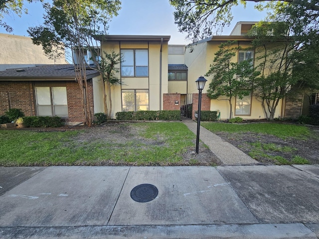 9807 Bent Branch Ln, Dallas, TX 75243 - multi unit property with stucco siding, brick siding, and a front yard