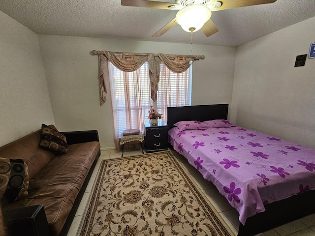 9807 Bent Branch Ln, Dallas, TX 75243 - bedroom featuring light tile patterned floors, a textured ceiling, and ceiling fan