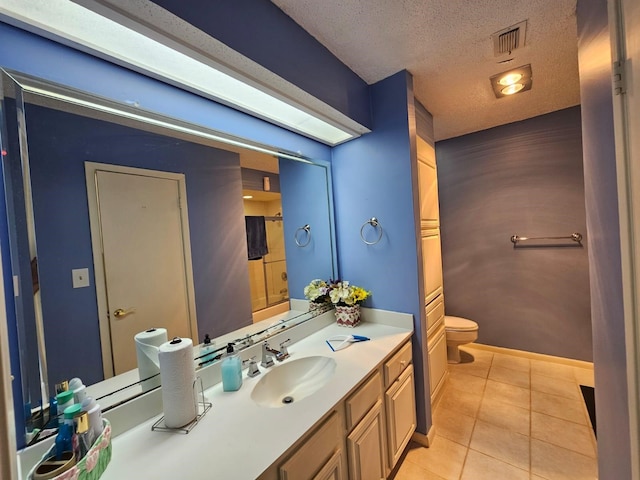 9807 Bent Branch Ln, Dallas, TX 75243 - full bathroom with tile patterned flooring, toilet, a textured ceiling, vanity, and baseboards