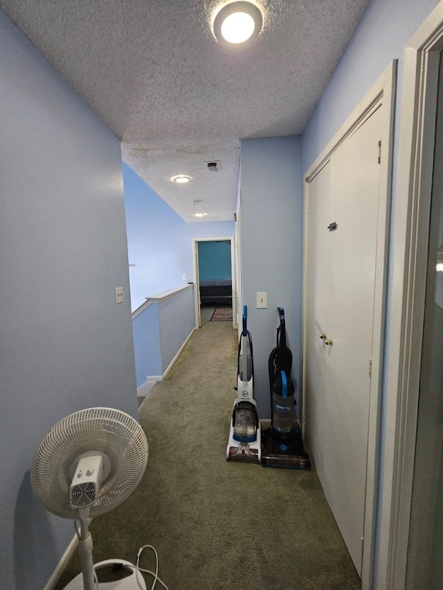 9807 Bent Branch Ln, Dallas, TX 75243 - hallway featuring a textured ceiling and carpet flooring