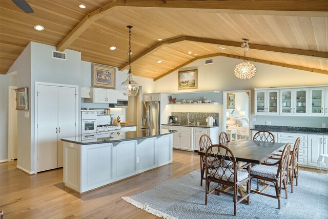 1378 Landing Way, Trinity, TX 75862 - kitchen featuring wood ceiling, dark countertops, stainless steel fridge, a chandelier, and white cabinetry