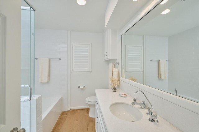 1378 Landing Way, Trinity, TX 75862 - bathroom with wood finished floors, toilet, vanity, a shower, and a tub to relax in