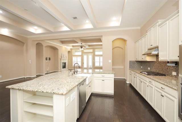 506 Chirping Sparrow Ct, Pinehurst, TX 77362 - kitchen featuring a sink, ceiling fan, arched walkways, appliances with stainless steel finishes, and beam ceiling