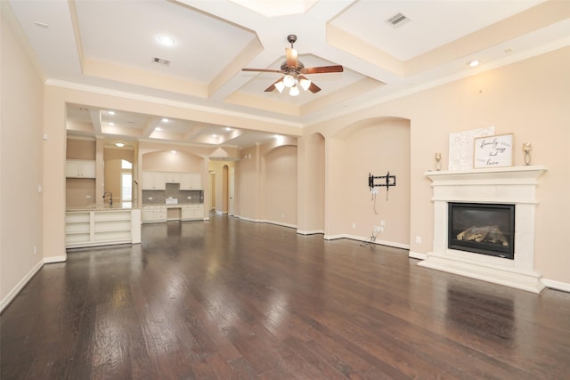 506 Chirping Sparrow Ct, Pinehurst, TX 77362 - unfurnished living room with coffered ceiling, a ceiling fan, dark wood finished floors, a glass covered fireplace, and beamed ceiling