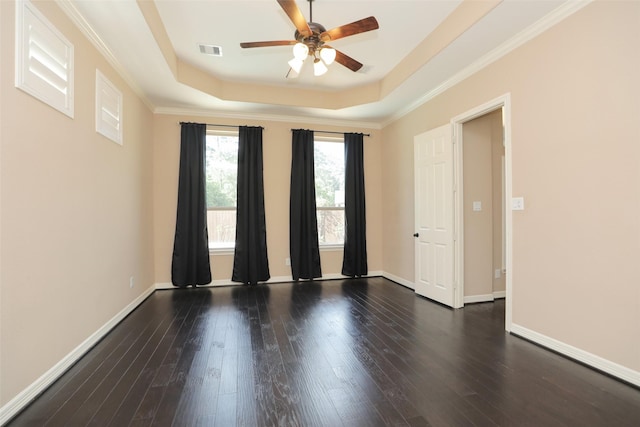 506 Chirping Sparrow Ct, Pinehurst, TX 77362 - empty room featuring ceiling fan, a raised ceiling, wood finished floors, baseboards, and crown molding