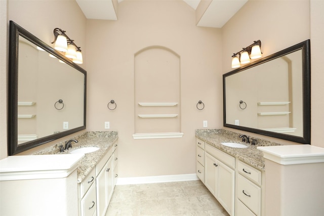 506 Chirping Sparrow Ct, Pinehurst, TX 77362 - bathroom with two vanities and baseboards