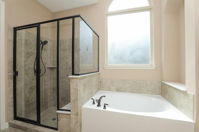 506 Chirping Sparrow Ct, Pinehurst, TX 77362 - full bathroom with healthy amount of natural light, a stall shower, and a garden tub