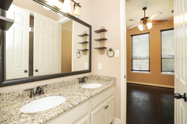 506 Chirping Sparrow Ct, Pinehurst, TX 77362 - bathroom with baseboards, ceiling fan, hardwood / wood-style floors, and double vanity
