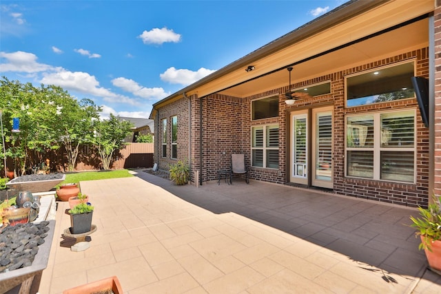 506 Chirping Sparrow Ct, Pinehurst, TX 77362 - view of patio featuring ceiling fan and fence