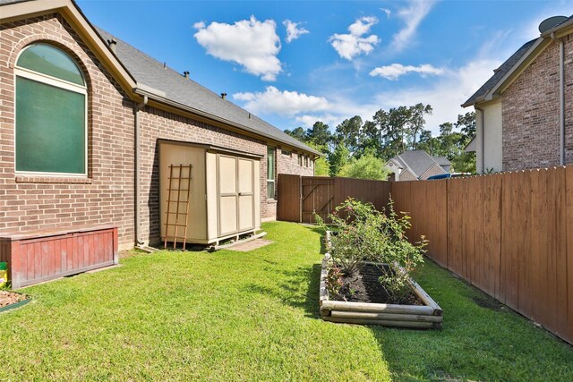 506 Chirping Sparrow Ct, Pinehurst, TX 77362 - view of yard featuring a vegetable garden, a storage shed, and an outbuilding