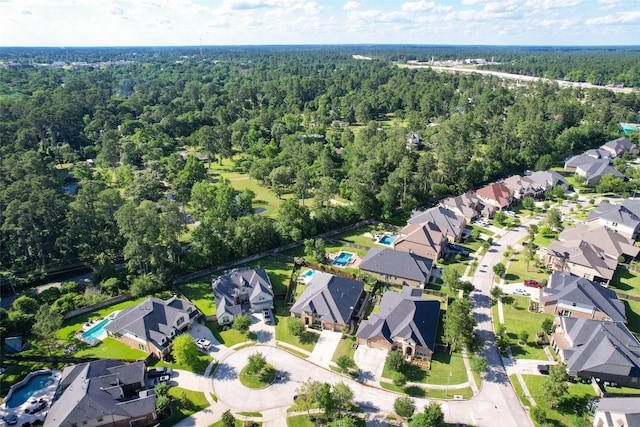506 Chirping Sparrow Ct, Pinehurst, TX 77362 - aerial view of property and surrounding area featuring a forest and nearby suburban area