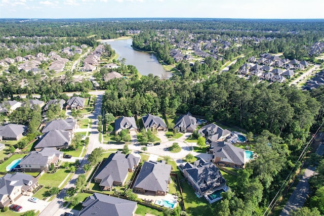 506 Chirping Sparrow Ct, Pinehurst, TX 77362 - aerial view of property's location with nearby suburban area, a forest, and a large body of water