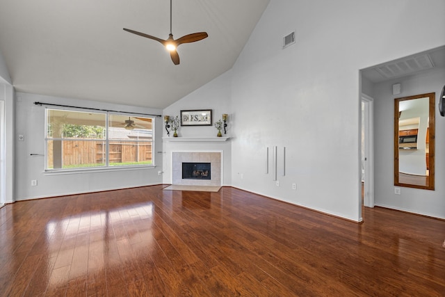 8414 Coriander Ln, Baytown, TX 77521 - unfurnished living room with hardwood / wood-style flooring, ceiling fan, a tiled fireplace, high vaulted ceiling, and baseboards