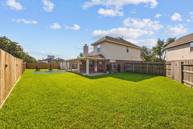 8414 Coriander Ln, Baytown, TX 77521 - back of property with a patio area, brick siding, a chimney, a storage unit, and an outbuilding