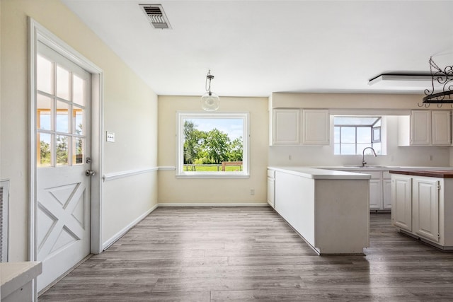 2368 Old Columbus Rd N, Sealy, TX 77474 - kitchen with dark wood-style flooring, a sink, white cabinetry, and baseboards
