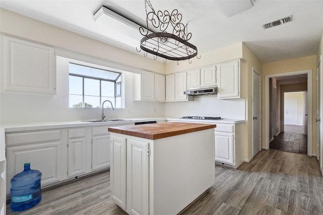 2368 Old Columbus Rd N, Sealy, TX 77474 - kitchen featuring a sink, butcher block counters, light wood finished floors, and white cabinetry