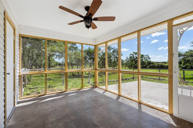 2368 Old Columbus Rd N, Sealy, TX 77474 - unfurnished sunroom featuring ceiling fan and view of wooded area