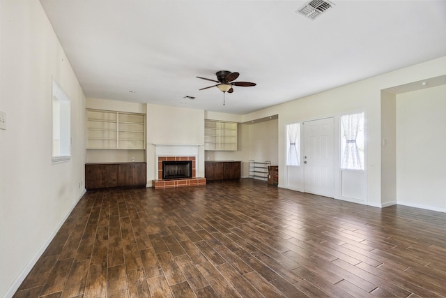 2368 Old Columbus Rd N, Sealy, TX 77474 - unfurnished living room with wood finished floors, a ceiling fan, baseboards, and a tile fireplace