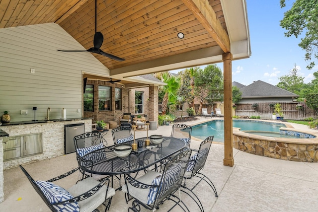 15730 Hunters Lake Way, Houston, TX 77044 - fenced backyard featuring exterior kitchen, a patio area, an in-ground hot tub, outdoor dining space, and ceiling fan